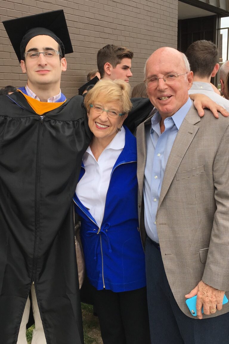 marv and carol lader standing with a young man in a graduation cap and gown